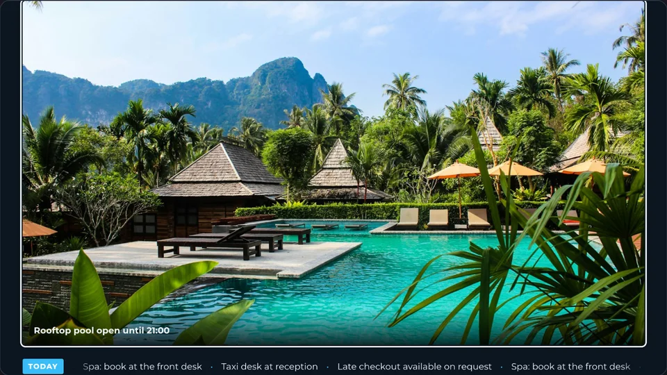 Hotel lobby signage with a pool photo, a notice and a scrolling ticker of hotel services